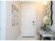 The entryway has a gallery wall with photos. The front door is painted white at 16300 County Road 455 # 606, Montverde, FL 34756