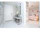Inviting foyer featuring a stylish console table, decorative mirror, and a glimpse into a charming bedroom at 16300 County Road 455 # 606, Montverde, FL 34756