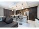 A modern kitchen with sleek dark cabinets, stainless steel appliances, and a breakfast bar with seating at 16300 County Road 455 # 606, Montverde, FL 34756