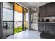Modern kitchen adjacent to a balcony, featuring a stylish display cabinet and seating with a view at 16300 County Road 455 # 606, Montverde, FL 34756
