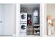 Bright laundry closet features a stacked washer/dryer and storage shelves at 16300 County Road 455 # 606, Montverde, FL 34756