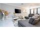 A stylish living area features a gray sofa, marble floors, and decorative accents, creating a chic ambiance at 16300 County Road 455 # 606, Montverde, FL 34756