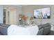 Cozy living room with comfortable seating and large-screen television displaying a theme park scene, creating a relaxing atmosphere at 16300 County Road 455 # 606, Montverde, FL 34756