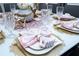 Elegant table setting with crystal glasses, gold cutlery and pink napkins at 16300 County Road 455 # 606, Montverde, FL 34756