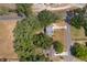 Aerial view of the property showcasing its mature trees and location on a corner lot at 201 Glenn St, Leesburg, FL 34748