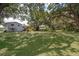 Expansive backyard featuring mature trees and ample lawn space at 201 Glenn St, Leesburg, FL 34748