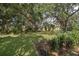 Beautiful backyard landscape with mature trees providing ample shade at 201 Glenn St, Leesburg, FL 34748