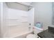 Clean bathroom featuring updated bathtub, dark counters, and neutral walls at 201 Glenn St, Leesburg, FL 34748