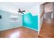 Upstairs bedroom with stairs, dark floors, neutral paint and lots of light at 201 Glenn St, Leesburg, FL 34748