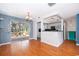 Bright dining area with hardwood floors, sliding glass doors, and a seamless transition to the modern kitchen at 201 Glenn St, Leesburg, FL 34748
