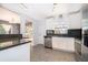 Updated kitchen featuring granite countertops, stainless steel appliances, and a seamless transition to the dining area at 201 Glenn St, Leesburg, FL 34748
