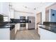 Modern kitchen with granite countertops, stainless steel appliances, and ample cabinet space at 201 Glenn St, Leesburg, FL 34748