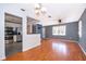Bright living room and modern kitchen featuring hardwood floors, natural light, and updated appliances at 201 Glenn St, Leesburg, FL 34748