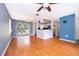Open-concept living and dining area featuring hardwood floors, natural light, and a view of the outdoor deck at 201 Glenn St, Leesburg, FL 34748