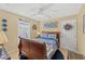 Bedroom with blue and white bedding, wood floors, natural light, and decorative wall art at 20321 Majestic St, Orlando, FL 32833