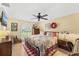 Bright bedroom with floral bedding, hardwood floors, and a window offering ample natural light at 20321 Majestic St, Orlando, FL 32833