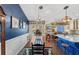 Inviting dining area with elegant chandelier, farmhouse table, and seamless connection to the living spaces at 20321 Majestic St, Orlando, FL 32833
