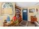 Cozy foyer featuring classic wooden furniture, decorative accents, and a welcoming blue entrance door at 20321 Majestic St, Orlando, FL 32833