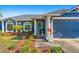 Charming home exterior with blue siding, a well-manicured lawn, and a vibrant front door at 20321 Majestic St, Orlando, FL 32833