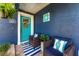 Inviting front porch with stylish seating, blue door, and decorative wreath, creating a welcoming entrance at 20321 Majestic St, Orlando, FL 32833