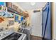 Functional laundry room with washer, dryer, storage shelves, and stylish barn door at 20321 Majestic St, Orlando, FL 32833