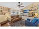 Comfortable living room with built-in shelving, nautical accents, and a ceiling fan at 20321 Majestic St, Orlando, FL 32833