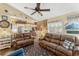 Spacious living area with leather seating, nautical accents, and a clear view of the kitchen at 20321 Majestic St, Orlando, FL 32833