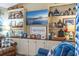 Built-in shelving in the living room adorned with nautical decor and a wall-mounted television at 20321 Majestic St, Orlando, FL 32833