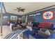 Spacious covered patio with seating, outdoor furniture, TV, and views of the yard at 20321 Majestic St, Orlando, FL 32833