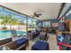 The covered patio features comfortable seating, a ceiling fan, and views of the sparkling pool at 20321 Majestic St, Orlando, FL 32833
