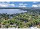 Aerial view showcasing a lakefront community with homes nestled among mature trees, featuring a scenic lake backdrop at 204 Green Lake Cir, Longwood, FL 32779
