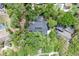 Stunning aerial view of a home with a dark roof, a pool, mature landscaping, and privacy at 204 Green Lake Cir, Longwood, FL 32779
