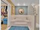 Bright bathroom highlighting the tub with glass block detail and separate walk-in closet at 204 Green Lake Cir, Longwood, FL 32779