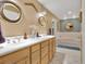 Bright bathroom featuring a double vanity, multiple mirrors, and a soaking tub at 204 Green Lake Cir, Longwood, FL 32779