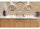 A well lit bathroom with double sink vanity, framed mirrors, and wood drawers at 204 Green Lake Cir, Longwood, FL 32779