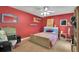 Bright bedroom with red walls, wood floors, and fun wall decor at 204 Green Lake Cir, Longwood, FL 32779