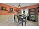 Dining room features warm paint, a modern light fixture, and decoratively arranged shelves at 204 Green Lake Cir, Longwood, FL 32779