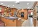 Open kitchen design with wooden cabinets, bar seating, and stainless steel appliances at 204 Green Lake Cir, Longwood, FL 32779