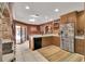 Spacious kitchen with stainless steel refrigerator, wooden cabinets, and an island at 204 Green Lake Cir, Longwood, FL 32779