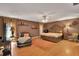 Spacious main bedroom with a carved wood bed frame, hardwood floors, sitting area, and large windows at 204 Green Lake Cir, Longwood, FL 32779