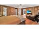 Spacious main bedroom featuring hardwood floors, ceiling fan, and a sitting area for relaxation at 204 Green Lake Cir, Longwood, FL 32779