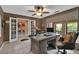 Home office with french doors and a large desk with a view of lush landscaping at 204 Green Lake Cir, Longwood, FL 32779