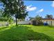 Spacious backyard featuring a large shed and plenty of green space, great for outdoor activities at 2120 Lilipetal Ct, Sanford, FL 32771