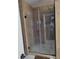 Glass shower with bronze hardware and tiled walls provides an updated and modern space at 2120 Lilipetal Ct, Sanford, FL 32771