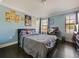 Comfortable bedroom with dark wood floors and ample natural light from two windows at 2120 Lilipetal Ct, Sanford, FL 32771