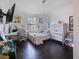Bright bedroom with dark wood floors, a window, and ample space for studying at 2120 Lilipetal Ct, Sanford, FL 32771
