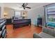 Bedroom with hardwood floors, a ceiling fan, and two windows bringing in ample natural light at 2120 Lilipetal Ct, Sanford, FL 32771