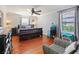 Bedroom with hardwood floors, a ceiling fan, and two windows bringing in ample natural light at 2120 Lilipetal Ct, Sanford, FL 32771