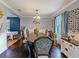 Traditional dining room with a dark wood table, ornate chairs, and elegant decor at 2120 Lilipetal Ct, Sanford, FL 32771