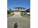 Two-story home featuring a two car garage, neat landscaping, and solar panels at 2120 Lilipetal Ct, Sanford, FL 32771